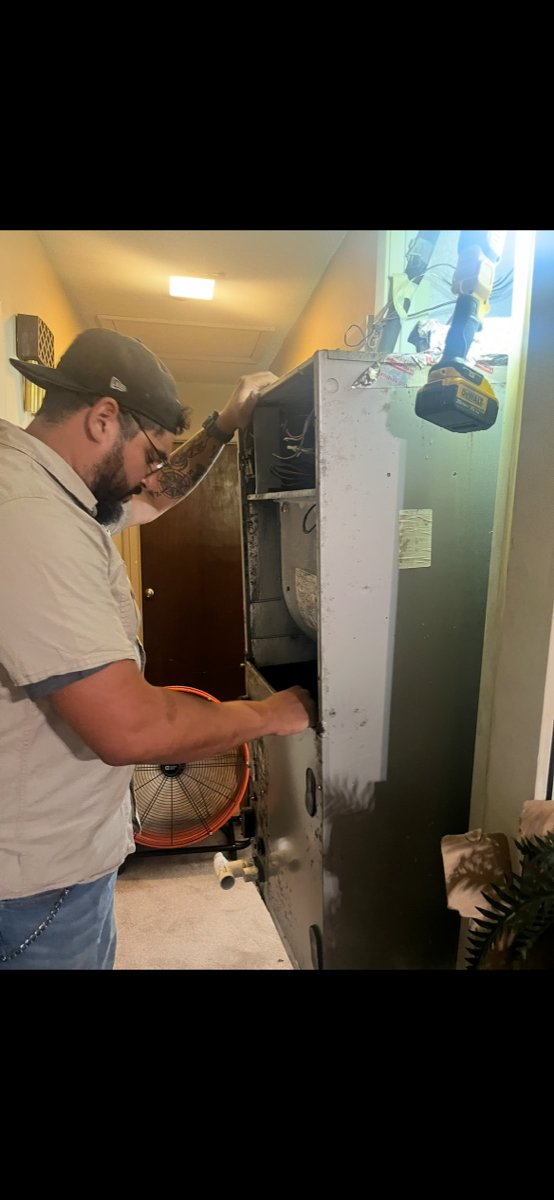 Ralph Oliver working on an HVAC system